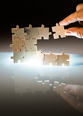 Image showing Wooden puzzle and backlight background. Close up