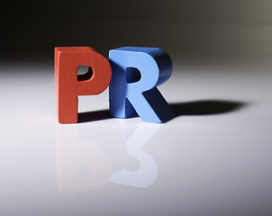 Image showing Multicolored word PR made of wood.