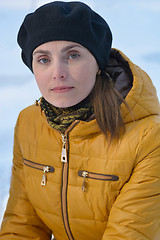 Image showing Woman in black beret and yellow jacket