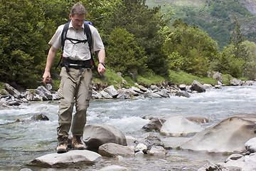 Image showing Crossing a river in the mountains