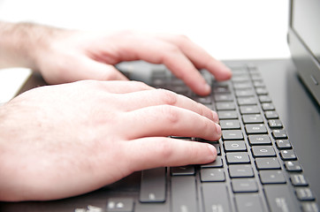 Image showing Hand on laptop keyboard