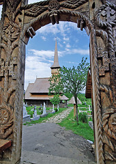 Image showing Wood gate and church