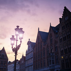 Image showing Silhouettes of city center houses in Bruges against beautiful su