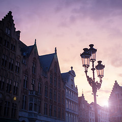 Image showing Silhouettes of city center houses in Bruges against beautiful su