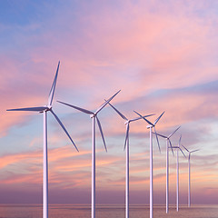 Image showing Wind generators turbines in the sea on sunset