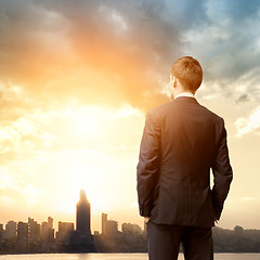Image showing business man look sunrise in the city