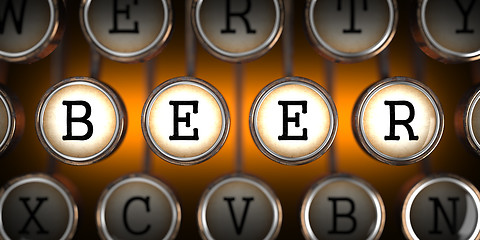 Image showing Beer on Old Typewriter's Keys.