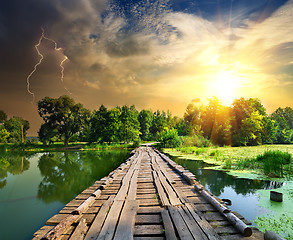 Image showing Lightning over the wooden bridge