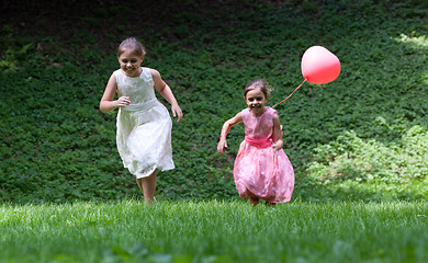 Image showing Two little girls running in park