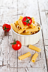 Image showing uncooked pasta and cherry tomatoes in a bowl 