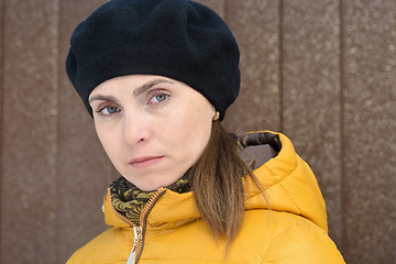 Image showing Woman in black beret and yellow jacket