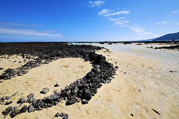 Image showing people spain  hill white  beach  spiral of black rocks     lanza