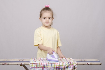 Image showing five year old girl stroking sheets