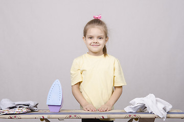 Image showing girl prepares to start ironed linen