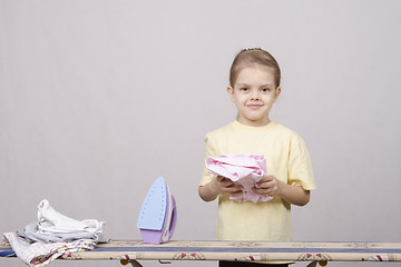Image showing the girl finished ironed clothes iron