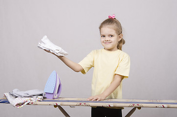 Image showing girl happy stroking things iron
