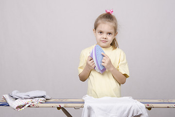 Image showing girl stands with iron hands