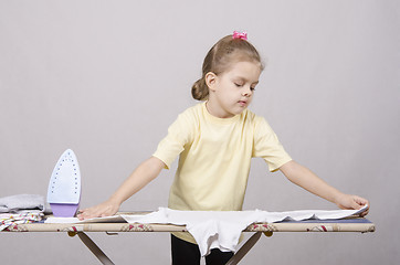 Image showing the girl gently stroking things iron