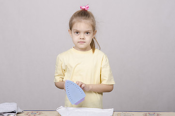 Image showing the girl standing near Ironing Board