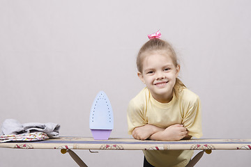 Image showing the girl smiles at Ironing Board