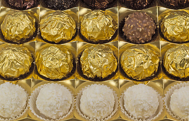 Image showing Chocolate sweets in the box on the white background.