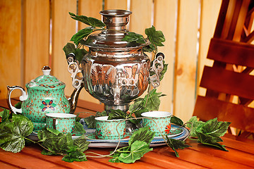 Image showing National Russian tradition to drink tea from a samovar.