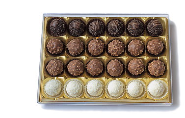 Image showing Chocolate sweets in the box on the white background.