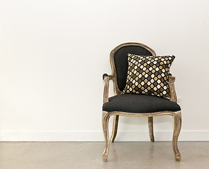 Image showing Antique armchair near wall