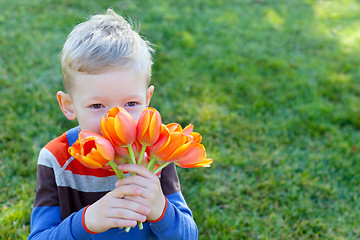 Image showing boy holding flowers