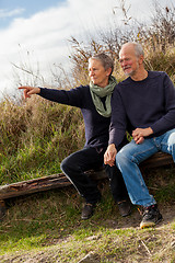 Image showing happy senior couple relaxing together in the sunshine