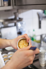 Image showing Chef preparing desserts removing them from moulds