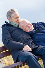 Image showing happy senior couple relaxing together in the sunshine