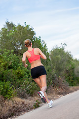 Image showing young athletic woman runner jogger outdoor