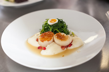 Image showing Delicious starter of stuffed savoury eggs and scallops