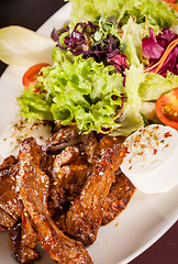 Image showing grilled beef stripes fresh salad and goat cheese