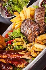 Image showing Platter of mixed meats, salad and French fries