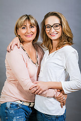 Image showing smiling middle-aged young mother and daughter