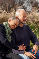 Image showing happy senior couple relaxing together in the sunshine