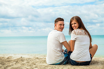 Image showing romantic young couple sitting on the beach in summer