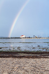 Image showing Rainbow over tidal mud flats at the coast