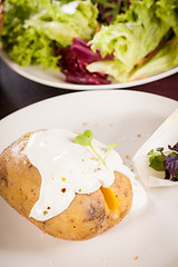 Image showing Baked jacket potato with sour cream sauce