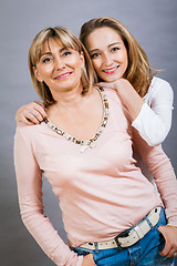 Image showing smiling middle-aged young mother and daughter