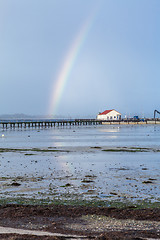 Image showing Rainbow over tidal mud flats at the coast