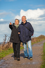 Image showing happy elderly senior couple walking on beach