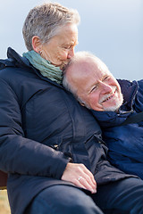 Image showing happy senior couple relaxing together in the sunshine