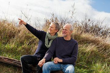 Image showing happy senior couple relaxing together in the sunshine