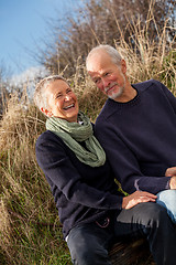 Image showing happy senior couple relaxing together in the sunshine