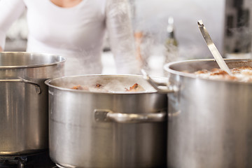 Image showing Cooking in a commercial kitchen