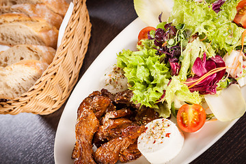 Image showing grilled beef stripes fresh salad and goat cheese