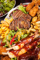 Image showing Platter of mixed meats, salad and French fries